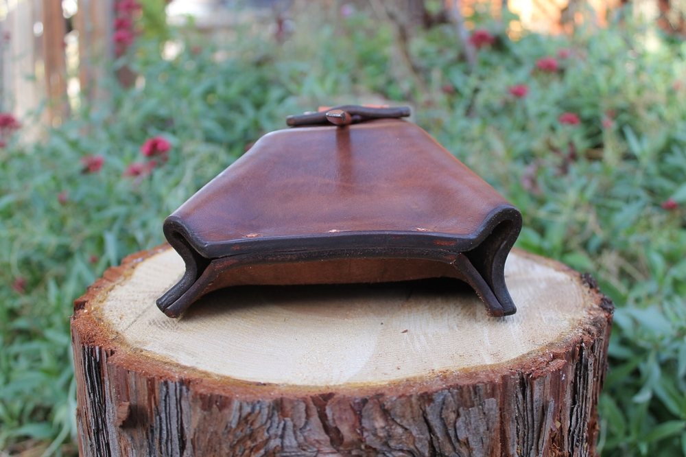 The wedge pouch seen from behind, the belt loops folded from the same piece of leather as the body